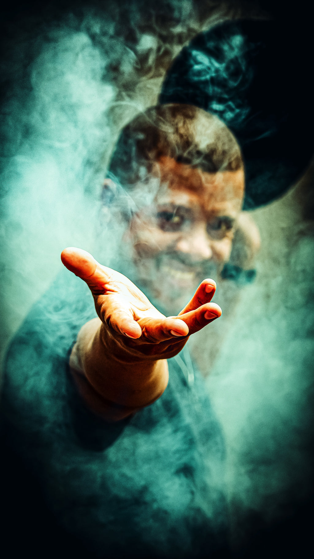 Dramatic fine art portrait of Brionne with a reaching hand emerging through swirling teal smoke, face half-revealed in the mist