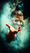 Dramatic fine art portrait of Brionne with a reaching hand emerging through swirling teal smoke, face half-revealed in the mist
