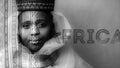 Black and white fine art portrait with bold AFRICA typography overlay, woman in traditional hat and silver neck rings with tribal pattern double exposure