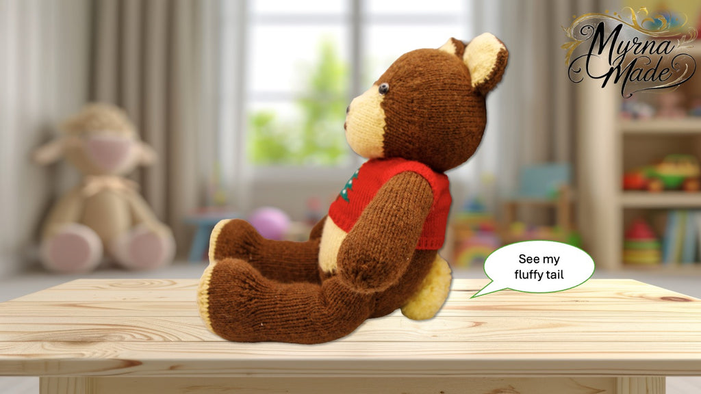 Brown teddy bear with a red shirt on a wooden table, with a blurred background of toys and a shelf.