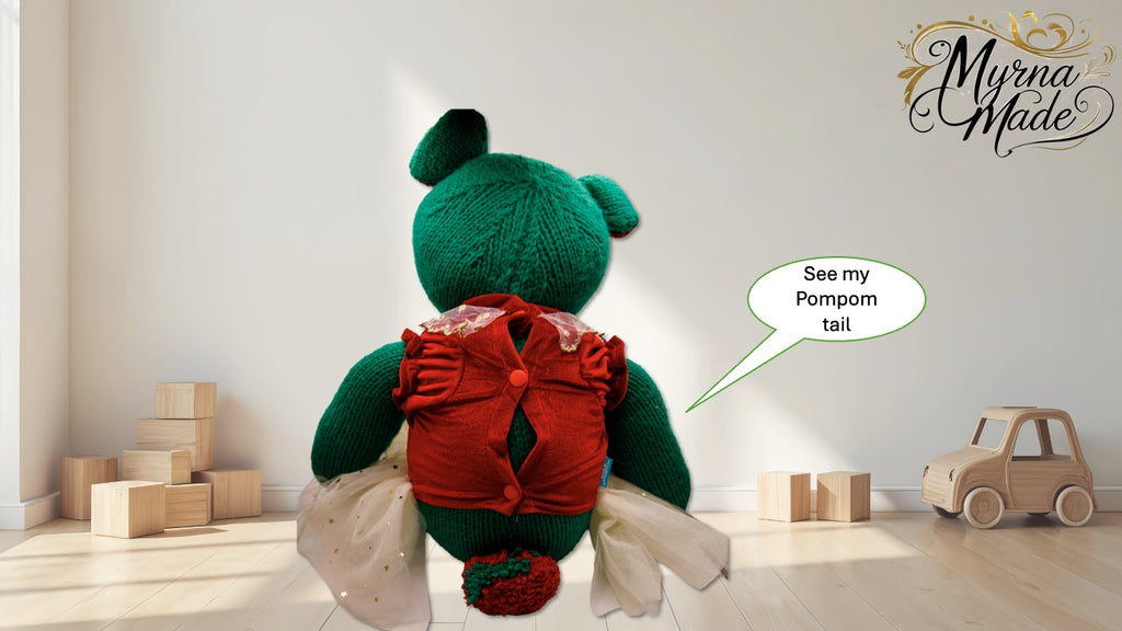 Green teddy bear with a red shirt and pom-pom tail in a room with wooden blocks and a toy car.