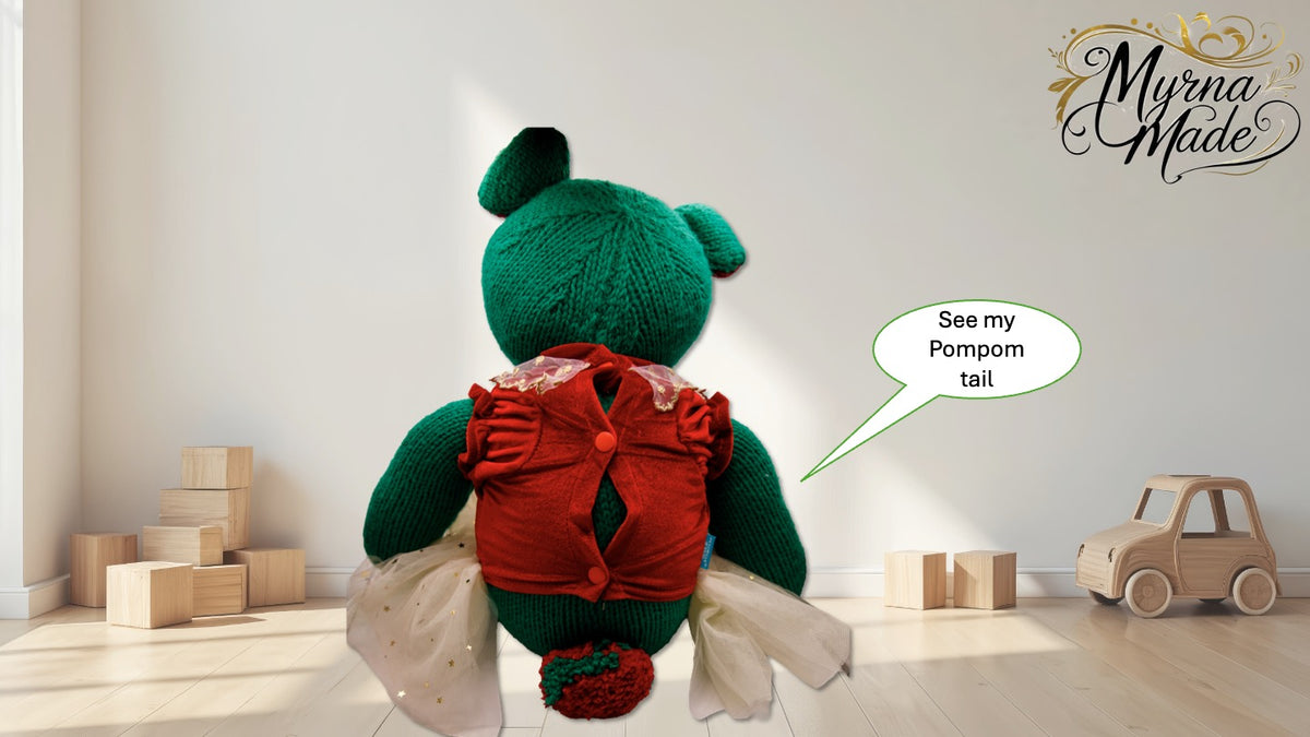 Green teddy bear with a red shirt and pom-pom tail in a room with wooden blocks and a toy car.