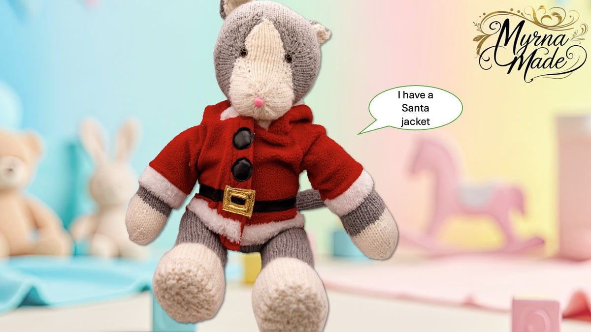 Knitted kitten in a Santa outfit with a speech bubble and 'Myrna Made' branding.