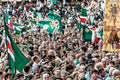 Thousands of Goose contrada supporters flooding the Campo with green flags and painted banners after their Palio di Siena victory, 3 July 2025