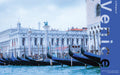 Gondolas moored along the Venice waterfront with San Marco columns and Biblioteca Marciana in the background