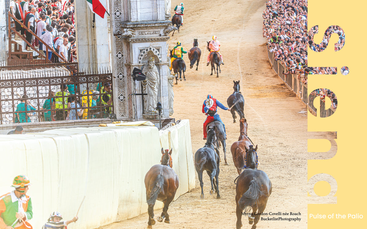 Horses and riders navigating the San Martino corner at the Palio di Siena with the historic cathedral facade in the background