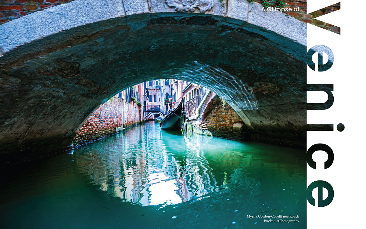 Gondola gliding through an emerald-green Venice canal framed by an ancient stone bridge arch